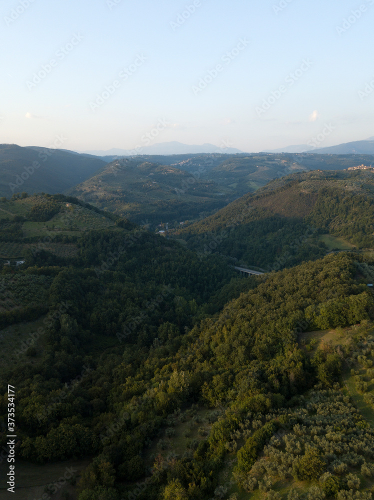 Aerial view of olive groves in the hills, olive trees on mountains, beautiful green valley, village near Rome, Frasso Sabino, Lazio, Italy, Europe.
