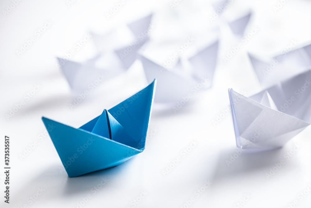 Blue and white paper boats. Concept of leadership boats for teamwork group or success Blue and white paper boats. Concept of leadership boats for teamwork group or success