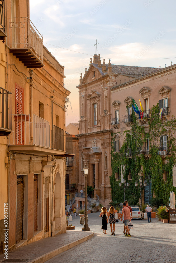 Fototapeta premium Agrigento, Sicilia, Italy - 18 August 2020 - Tourists walk on via Atenea towards piazza Pirandello