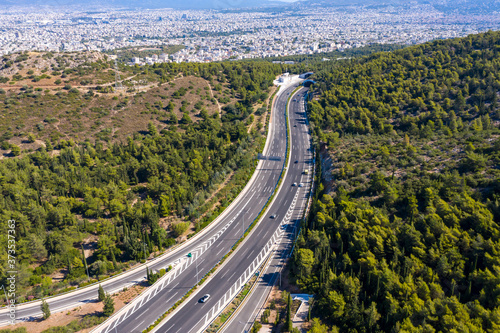 Aerial drone view of regional highway of Hymettus mountain  Greece  Athens city background.
