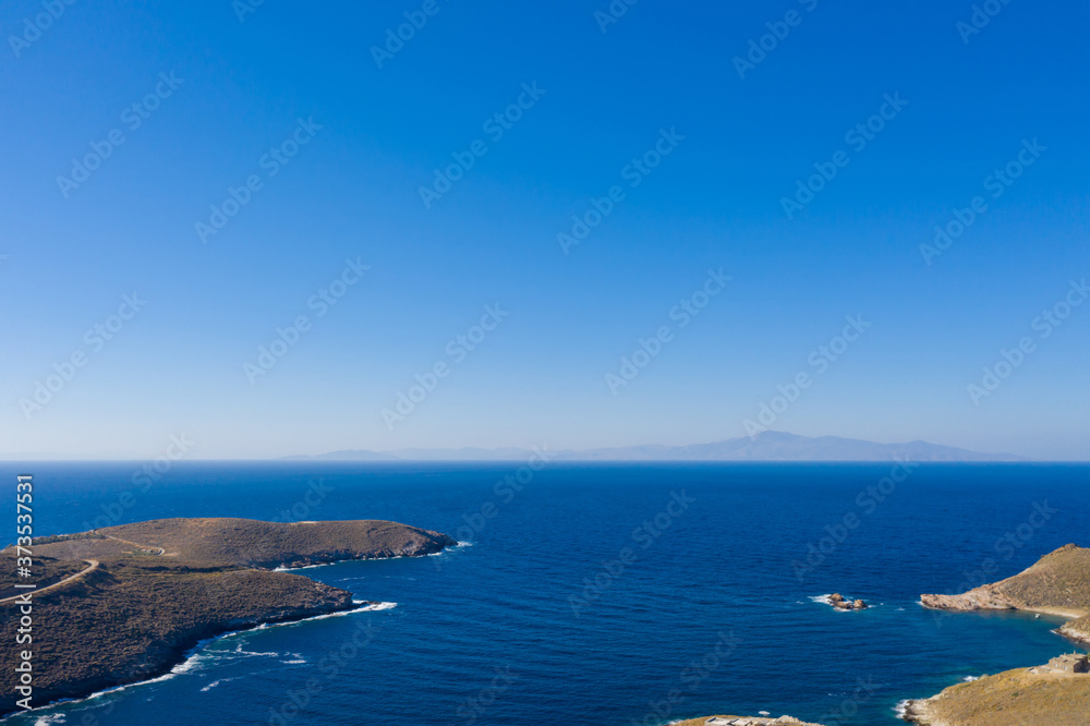 Calm clear water, blue sky background. Aerial drone view