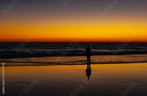 A woman looks to the horizon, perhaps to her future, in a wonderful sunset