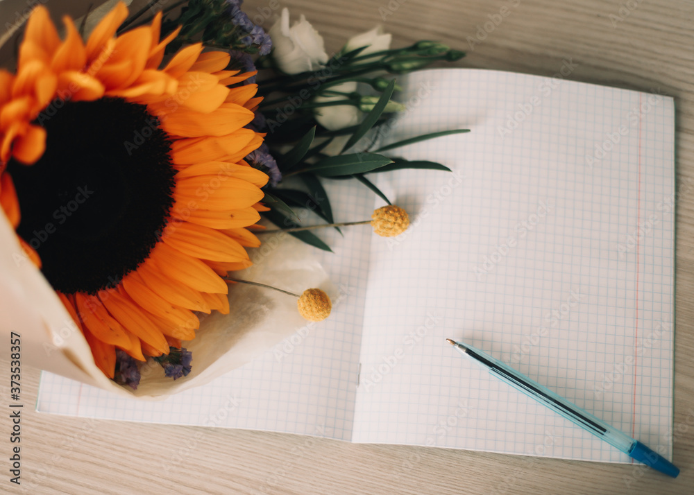 1 September. Bouquet with sunflower and school supplies on table. Hello autumn concept.  Back to school, Knowledge Day