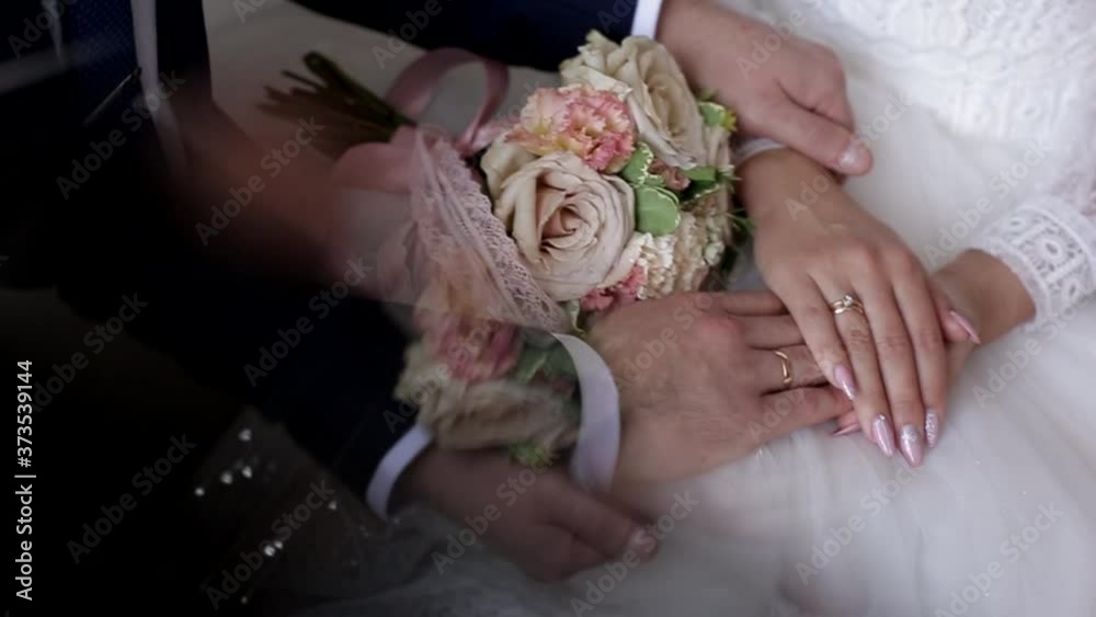 the bride and groom hold hands, the hands of a man and a woman close-up the bride and groom hold hands, the hands of a man and a woman close-up