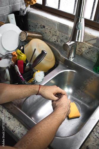 Obraz na plátně Washing dishes because in quarantine, dirty dishes do not stop.