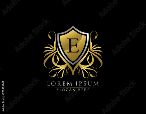 Gold Royal Shield E Letter Logo. Graceful Elegant gold shield icon design.