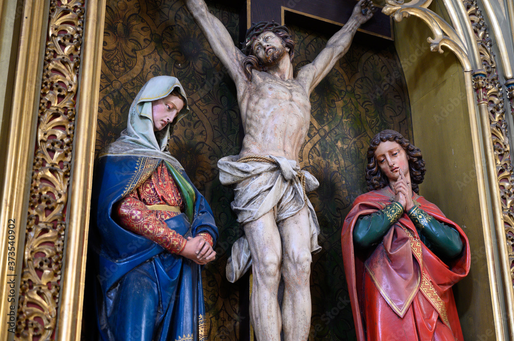 Fototapeta premium The Crucifixion – Sculpture of Jesus Christ on the cross with the Virgin Mary and Saint John beside Him. St Martin's Cathedral in Bratislava, Slovakia. 2020/05/20.
