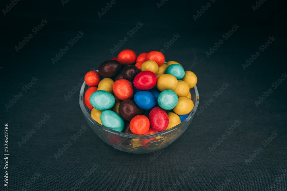 colorful chocolate candies in a glass bowl colorful chocolate candies in a glass bowl