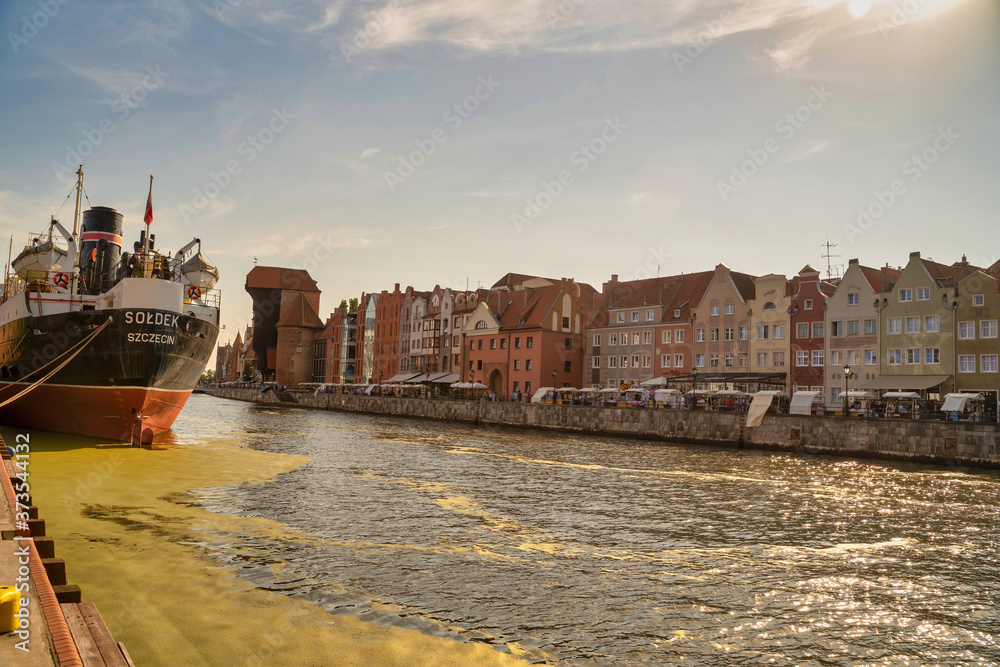 Gdansk, North Poland : Sunset Panoramic view of Summer around motlawa river adjacent to beautiful Polish architecture near baltic sea and ship docked on left