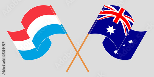 Crossed and waving flags of Luxembourg and Australia