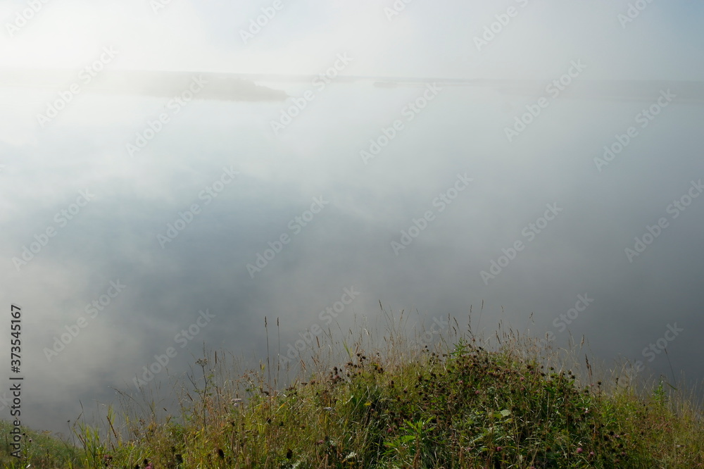 early morning, fog over the river. View from the high Bank early morning, fog over the river. View from the high Bank