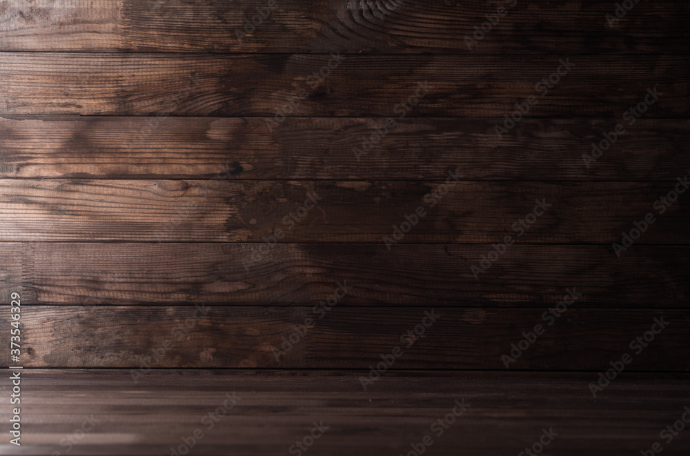 Naklejka premium Textured wooden background from dark planks, empty wooden table at the bottom.