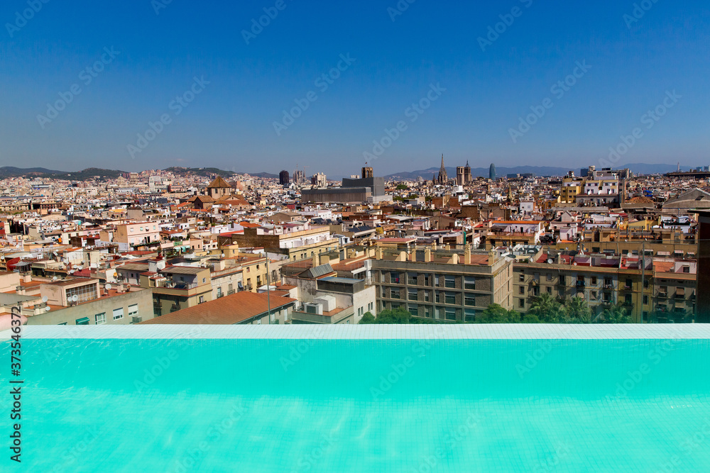 Fototapeta premium Barcelona, Catalonia, Europe, Spain, September 22, 2019. Top panoramic view of the Barcelona landscape from infinity swimmingpool. Historical buildings in the background.