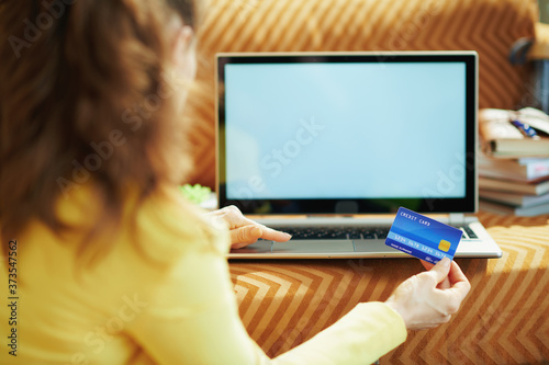 female with credit card and laptop blank screen
