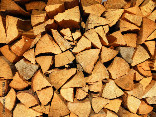 Dry chopped firewood logs in a pile.