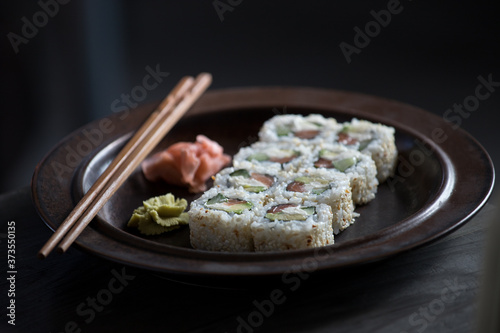sushi on a brown plate