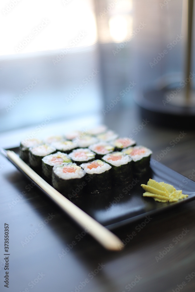 Sushi on a black plate