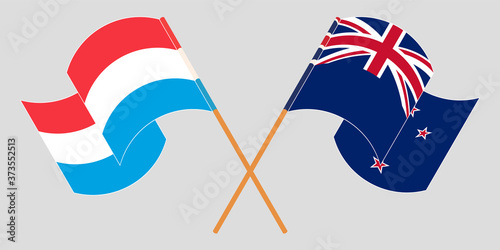 Crossed and waving flags of Luxembourg and New Zealand