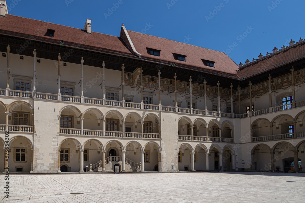 without people courtyard with arcades at the Wawel Royal Castle in Krakow, Poland on a sunny summer day