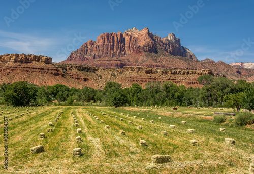 Hay Harvest Beneath Rugged Utah Mountains