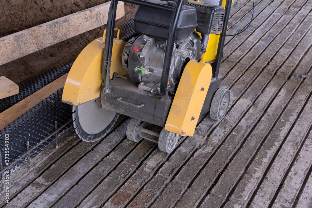 Concrete cutting machine. Equipment for the processing of concrete surfaces. Diamond cutting of materials at the construction site. Concrete cutting machine. Equipment for the processing of concrete surfaces. Diamond cutting of materials at the construction site.
