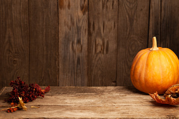 autumn pumpkins and dry berry on a wooden table, thanksgiving, halloween background mockup