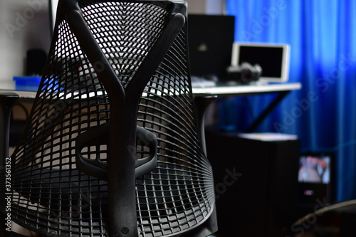 The ultime tecnology devices for a smart home. Wireless devices for videogame play with a confortable gamer chair photo