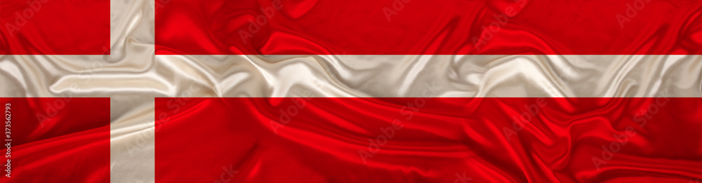 long panorama of the national flag of the state of Denmark on delicate silk with folds, the concept of tourism, emigration, economy, politics, global world trade