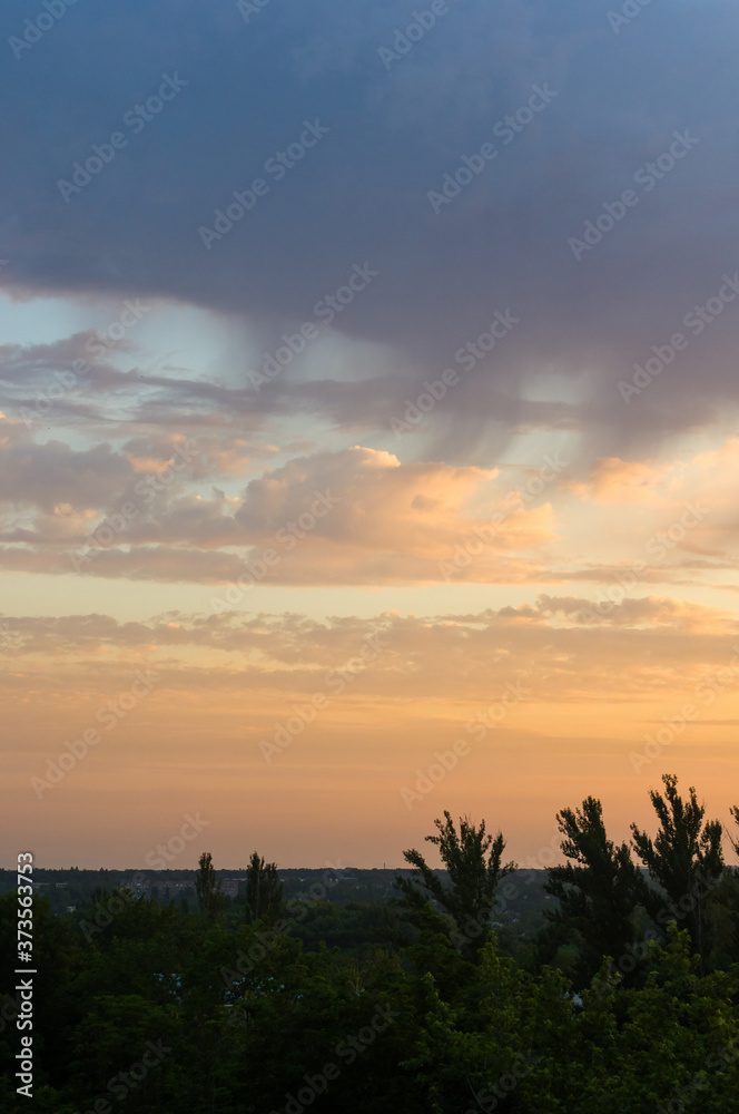 Landscape with dramatic light - beautiful golden sunset with saturated sky and clouds.