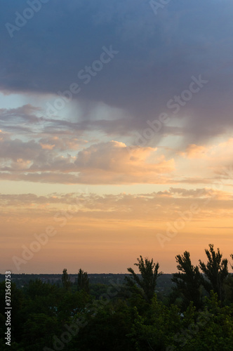 Landscape with dramatic light - beautiful golden sunset with saturated sky and clouds.