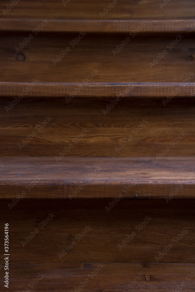 Vertical close-up photo of steps on a wooden staircase