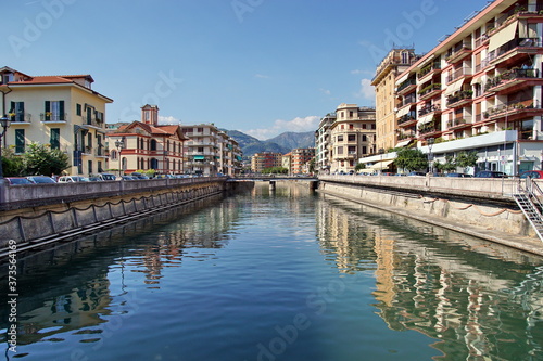 The beautiful Italian town of Rapallo, overlooking the streets of the city with the river, bridges, mountains. The urban landscape in Italy. © otmman