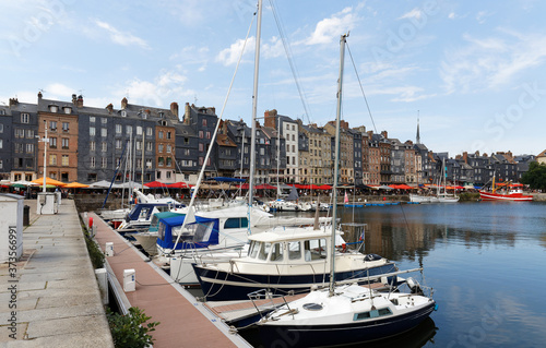 Honfleur harbour in Normandy, France. Color houses and their reflection in water.