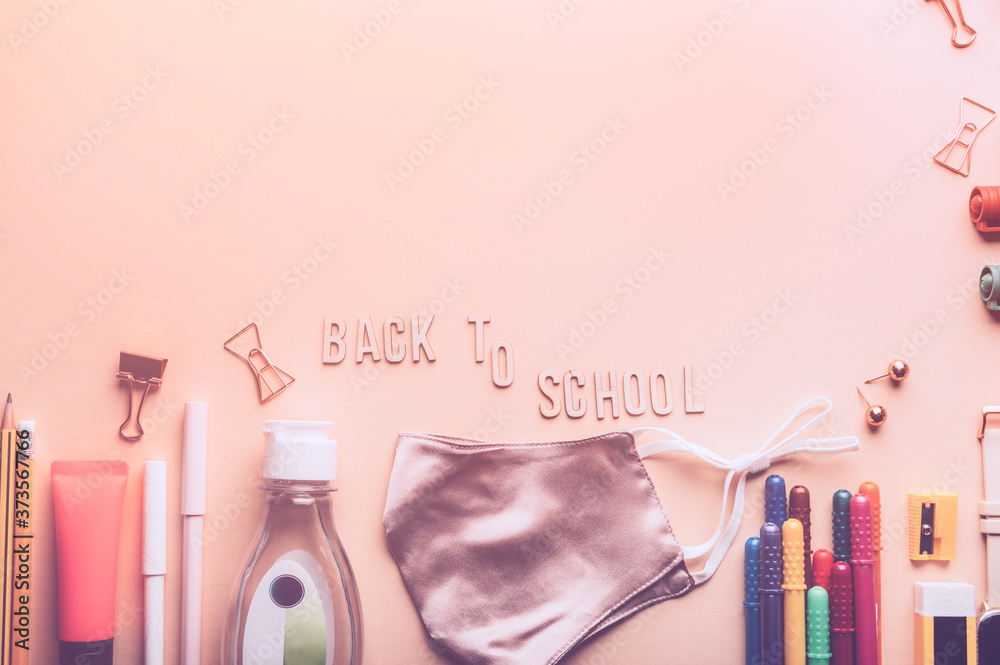 Back to school wooden letters. Preparation for going back to school with usual stationery and new normal such as face mask and hand cleanser gel Back to school wooden letters. Preparation for going back to school with usual stationery and new normal such as face mask and hand cleanser gel