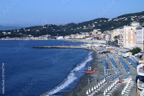Fototapeta Naklejka Na Ścianę i Meble -  The beach and the houses of the Varazze promenade with the homonymous gulf in the background.Varazze is a town located in the western Ligurian Riviera, 30 kilometers from Genoa. 