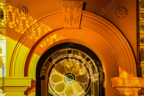 Patterned architectural shadows on a yellow wall.