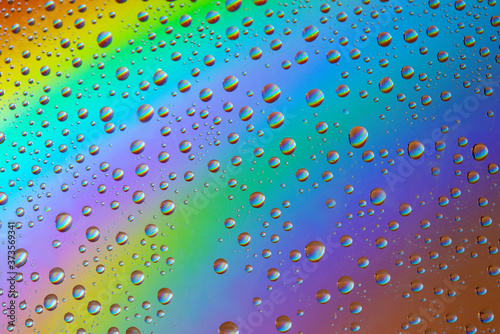 Water drops on rainbow background