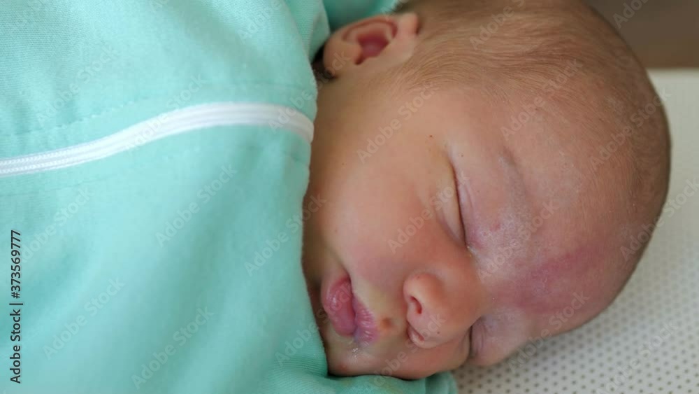 Newborn male baby sleeping calmly in maternity hospital Newborn male baby sleeping calmly in maternity hospital