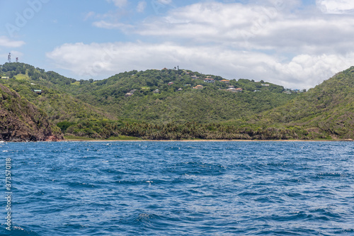Saint Vincent and the Grenadines,windward side of Bequia with bay and buildings on the hill