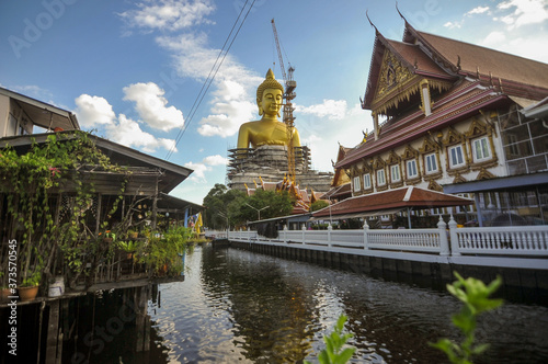 The construction site of the Big golden buddha statue at Wat Paknam temple nearby Phasi charoen canal in Bangkok Thailand 