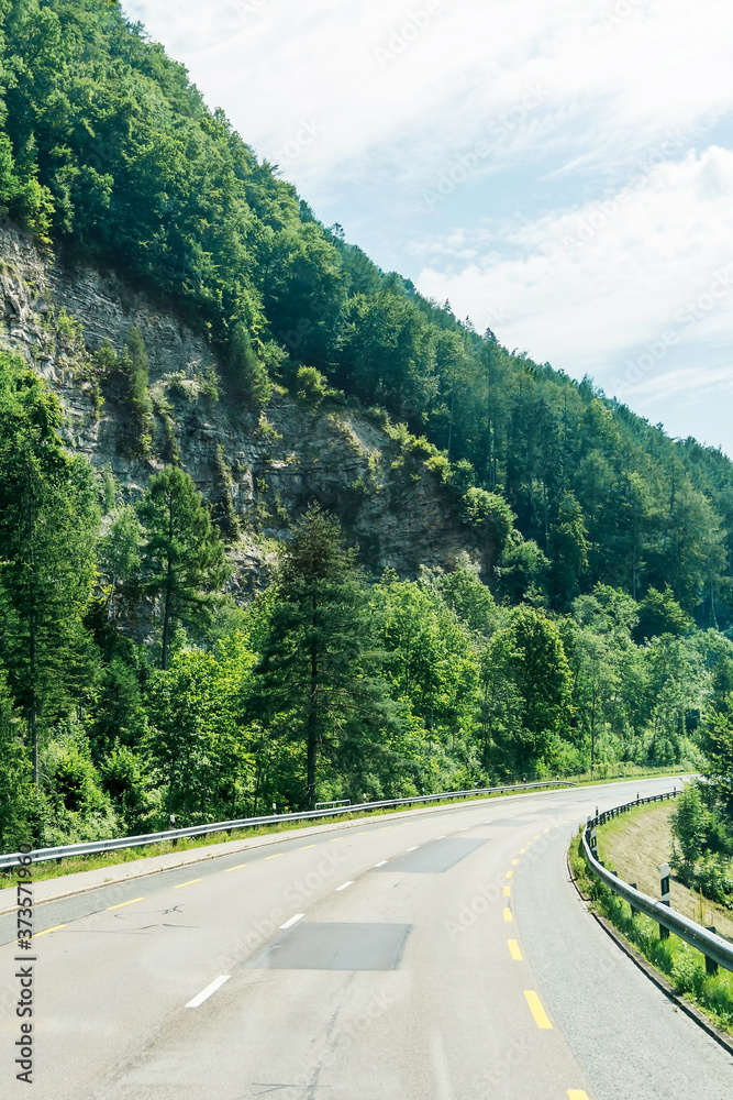 Turning the road in the mountains. Mountain serpentine. Traveling by car in Europe. Mountains in Germany. An asphalt road along the cliff. Mountain trail. Turning the road in the mountains. Mountain serpentine. Traveling by car in Europe. Mountains in Germany. An asphalt road along the cliff. Mountain trail.