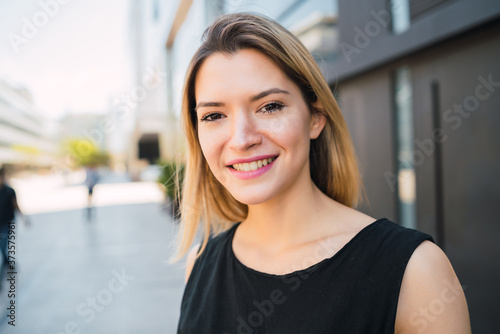 Business woman standing outside office buildings. © Mego-studio