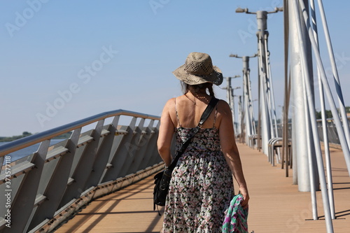 A woman with a hat. A pier on the Vistula river in Płock, Poland