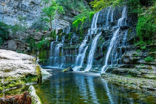 A beautiful waterfall amongst rocks. Nature background.
