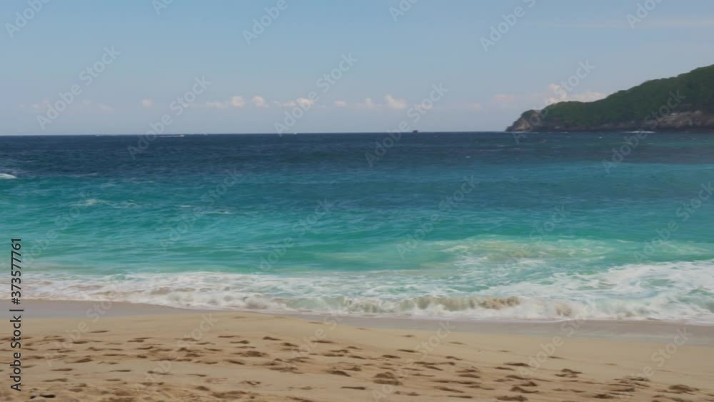 Azure beach with rocky mountains and clear water of Indian ocean at sunny day Azure beach with rocky mountains and clear water of Indian ocean at sunny day