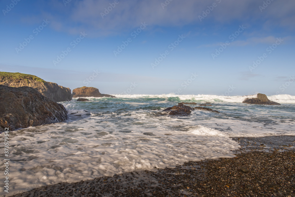 Waves breaking on rocks on the beach