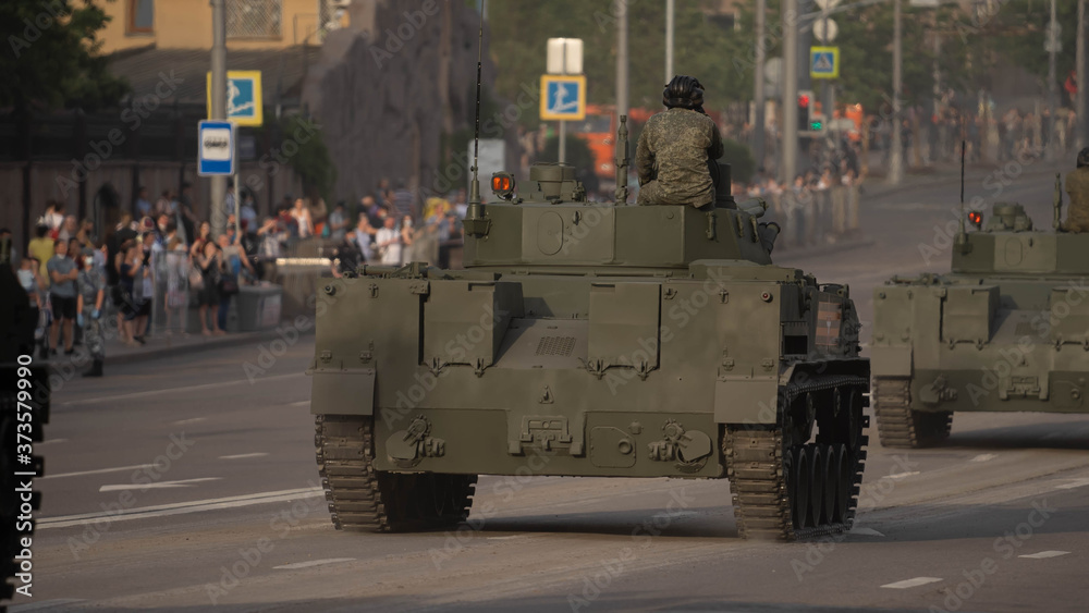 a soldier sits on a tank during a rehearsal of the military parade . June 2020