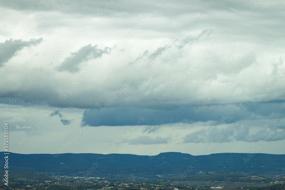 Summer landscape in mountains and the dark blue sky with clouds