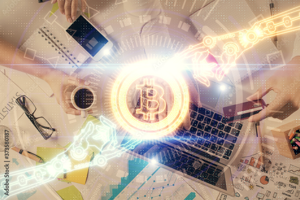Double exposure of man's hands typing over computer keyboard and crypto currency theme hologram drawing. Top view. Blockchain concept. Double exposure of man's hands typing over computer keyboard and crypto currency theme hologram drawing. Top view. Blockchain concept.