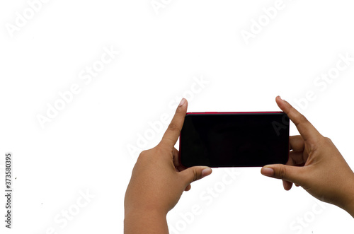 Hand of a teenage woman holding a mobile phone to take pictures isolated on white background